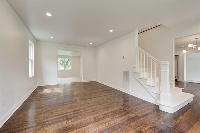 2836 NW 43rd St, Oklahoma City, OK 73112 - empty room with wood finished floors, stairs, recessed lighting, and a chandelier