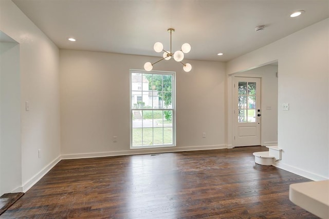 2836 NW 43rd St, Oklahoma City, OK 73112 - spare room with plenty of natural light, dark wood-style flooring, a chandelier, recessed lighting, and a smoke detector