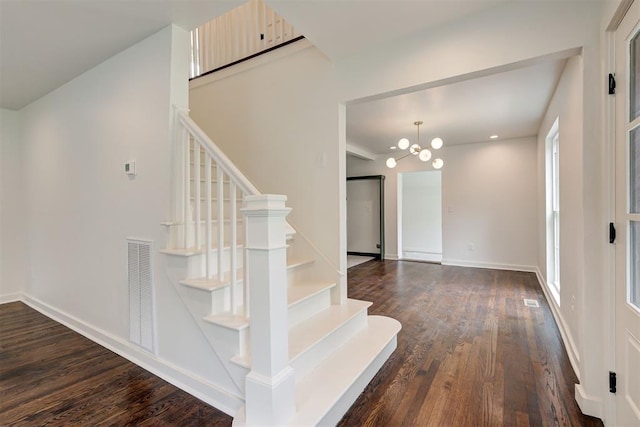 2836 NW 43rd St, Oklahoma City, OK 73112 - stairway featuring wood finished floors and a chandelier