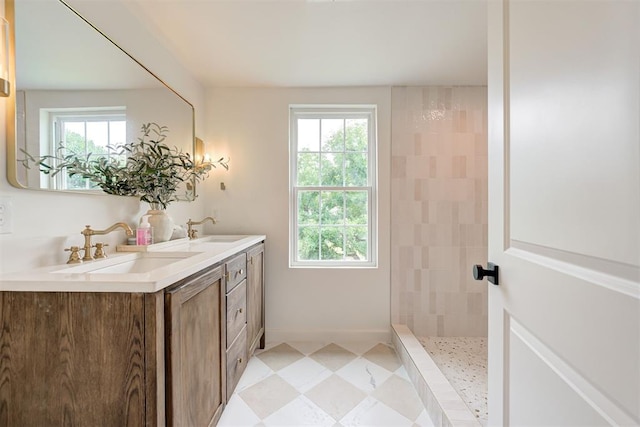 2836 NW 43rd St, Oklahoma City, OK 73112 - bathroom featuring healthy amount of natural light, double vanity, and a tile shower