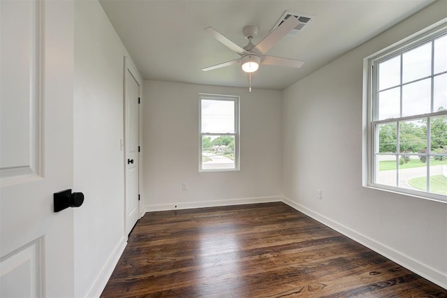 2836 NW 43rd St, Oklahoma City, OK 73112 - unfurnished room featuring healthy amount of natural light, dark wood-style flooring, and ceiling fan