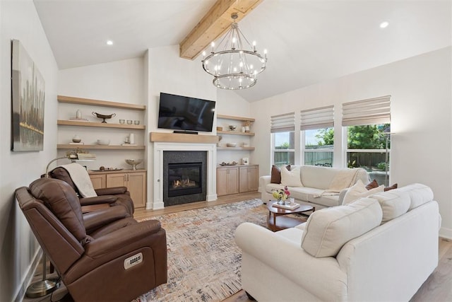 200 Pont Neuf Ct, Edmond, OK 73034 - living area featuring light wood-type flooring, beamed ceiling, a chandelier, a glass covered fireplace, and high vaulted ceiling