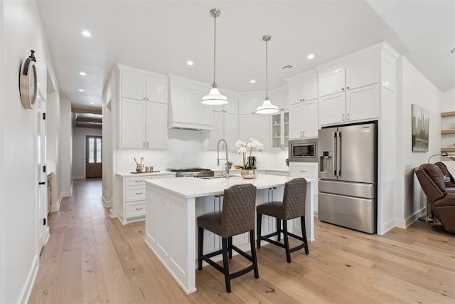 200 Pont Neuf Ct, Edmond, OK 73034 - kitchen with stainless steel appliances, light countertops, white cabinets, tasteful backsplash, and recessed lighting