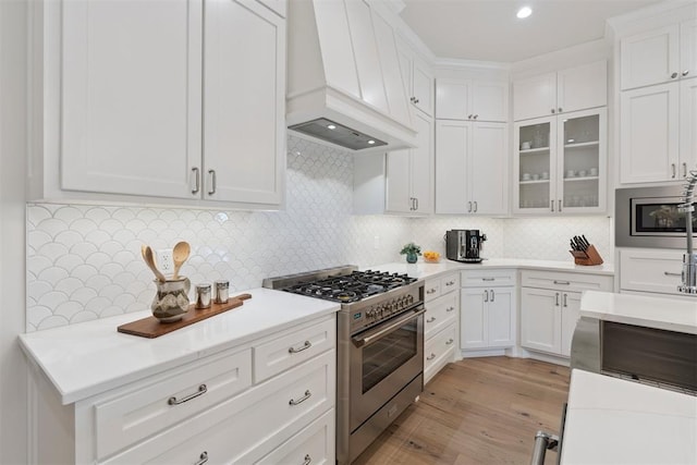 200 Pont Neuf Ct, Edmond, OK 73034 - kitchen with stainless steel appliances, premium range hood, white cabinetry, light countertops, and backsplash