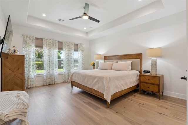200 Pont Neuf Ct, Edmond, OK 73034 - bedroom with a raised ceiling, light wood-type flooring, recessed lighting, and a ceiling fan