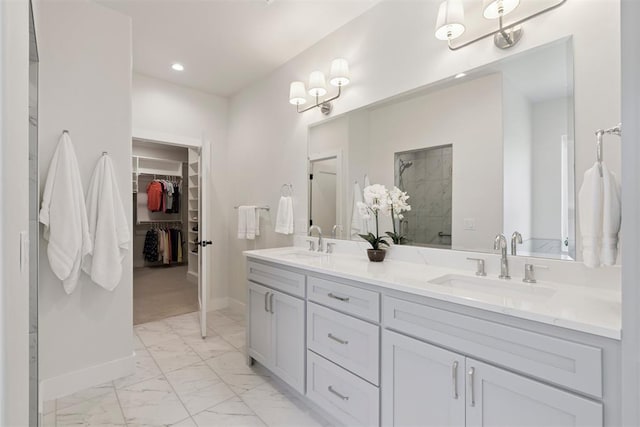 200 Pont Neuf Ct, Edmond, OK 73034 - bathroom with marble look tiles, double vanity, a shower stall, a spacious closet, and recessed lighting