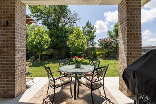 200 Pont Neuf Ct, Edmond, OK 73034 - fenced backyard with outdoor dining space, a patio, and area for grilling