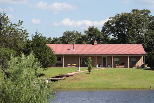 11800 Bryant Rd, Lexington, OK 73051 - back of house with board and batten siding, a yard, a water view, a metal roof, and a chimney