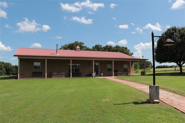 11800 Bryant Rd, Lexington, OK 73051 - back of house with board and batten siding, a lawn, and a metal roof