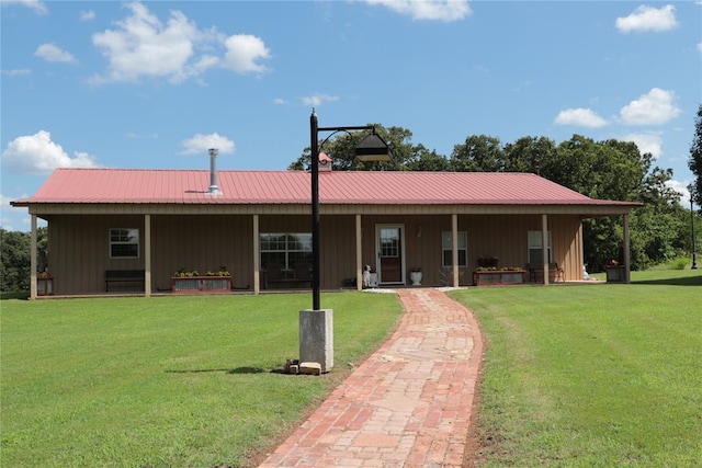 11800 Bryant Rd, Lexington, OK 73051 - back of house with board and batten siding, a yard, and a metal roof