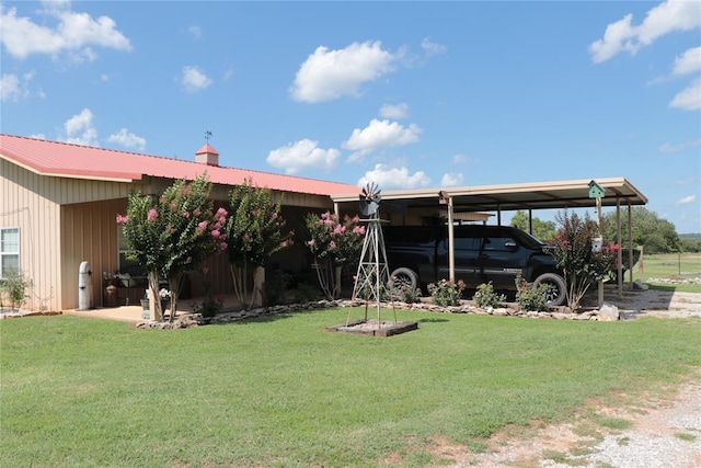 11800 Bryant Rd, Lexington, OK 73051 - rear view of house with a carport, a lawn, a metal roof, and a chimney