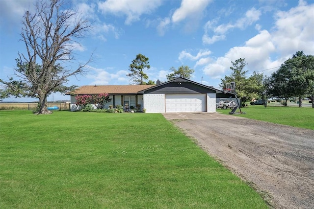 323 W 13th St, Snyder, OK 73566 - ranch-style house with a garage and asphalt driveway