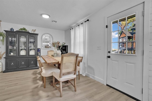 323 W 13th St, Snyder, OK 73566 - dining room with light wood-style flooring and healthy amount of natural light