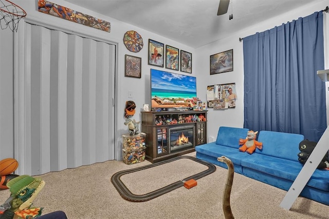 323 W 13th St, Snyder, OK 73566 - carpeted living room featuring a glass covered fireplace and ceiling fan