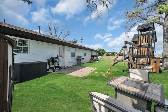 323 W 13th St, Snyder, OK 73566 - view of grassy yard with a playground and a patio