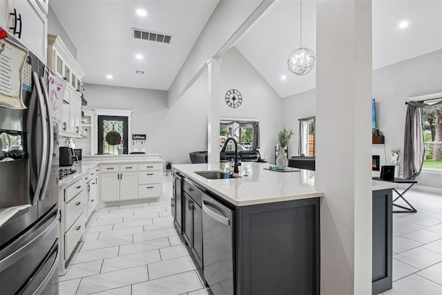 9228 E Cardinal Pl, Midwest City, OK 73130 - kitchen featuring stainless steel appliances, white cabinets, glass insert cabinets, a peninsula, and a chandelier