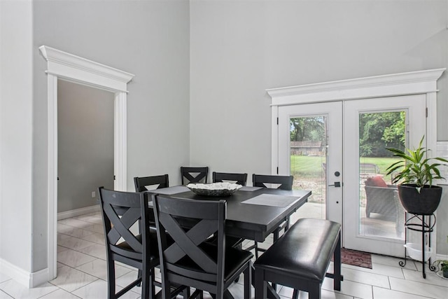 9228 E Cardinal Pl, Midwest City, OK 73130 - dining space featuring french doors, a towering ceiling, and light marble finish flooring