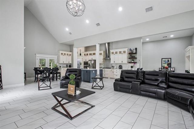 9228 E Cardinal Pl, Midwest City, OK 73130 - living area featuring high vaulted ceiling, recessed lighting, decorative columns, and a chandelier