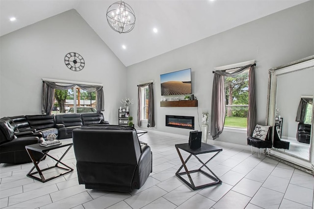 9228 E Cardinal Pl, Midwest City, OK 73130 - living room featuring high vaulted ceiling, a glass covered fireplace, recessed lighting, and a chandelier