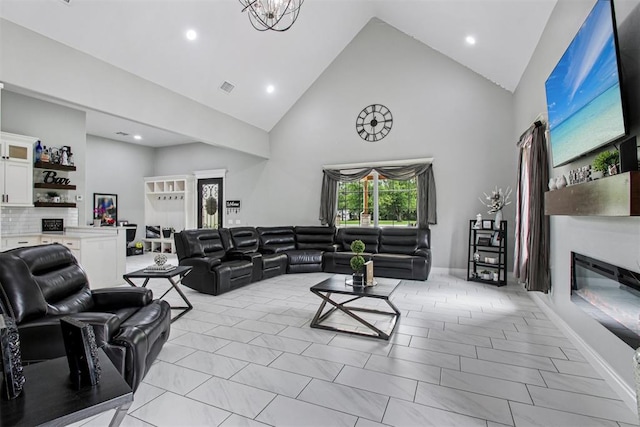 9228 E Cardinal Pl, Midwest City, OK 73130 - living area featuring high vaulted ceiling, a glass covered fireplace, and recessed lighting