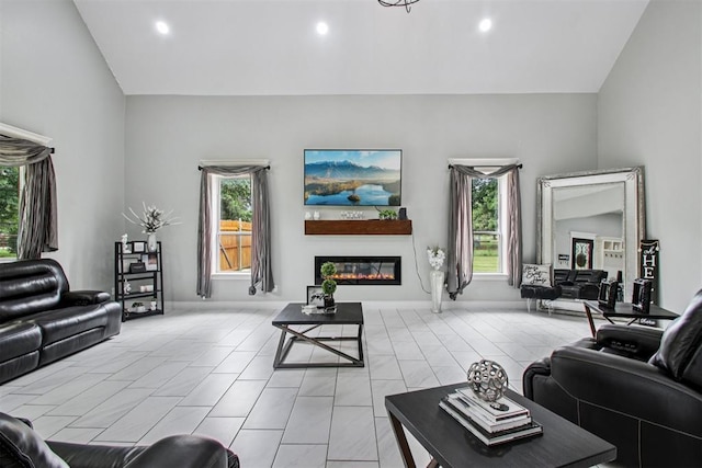 9228 E Cardinal Pl, Midwest City, OK 73130 - living area with vaulted ceiling, plenty of natural light, a glass covered fireplace, recessed lighting, and light tile patterned flooring