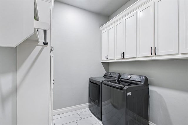 9228 E Cardinal Pl, Midwest City, OK 73130 - laundry area featuring separate washer and dryer, cabinet space, and light marble finish flooring