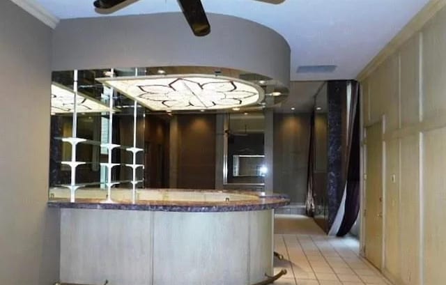 5720 Irvine Dr, Edmond, OK 73025 - indoor bar featuring ceiling fan and tile patterned flooring