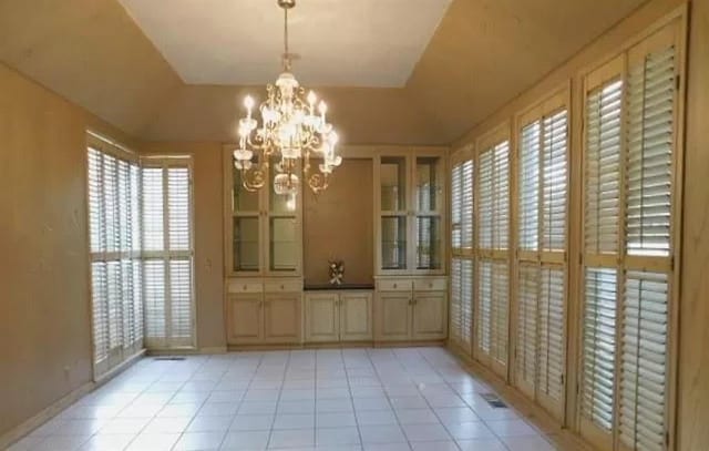5720 Irvine Dr, Edmond, OK 73025 - unfurnished dining area with light tile patterned floors, a chandelier, and healthy amount of natural light