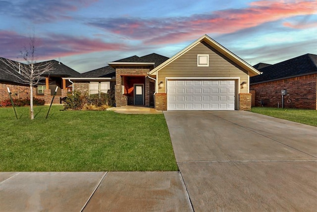 9021 NW 74th St, Yukon, OK 73099 - view of front of home with driveway, brick siding, a lawn, and an attached garage