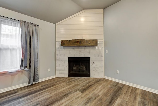 9021 NW 74th St, Yukon, OK 73099 - unfurnished living room featuring wood finished floors, lofted ceiling, and a fireplace