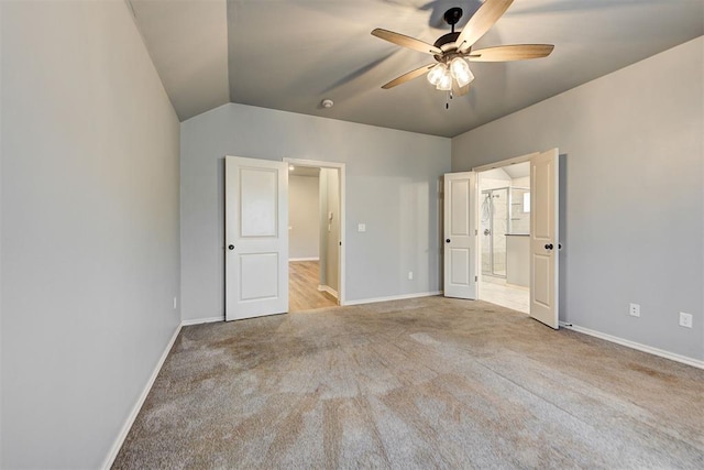 9021 NW 74th St, Yukon, OK 73099 - unfurnished bedroom featuring carpet flooring, lofted ceiling, connected bathroom, and ceiling fan