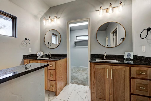 9021 NW 74th St, Yukon, OK 73099 - full bath with two vanities, marble finish flooring, and vaulted ceiling