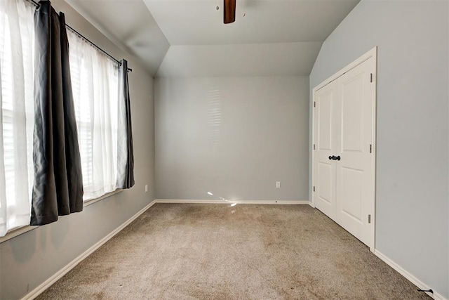 9021 NW 74th St, Yukon, OK 73099 - carpeted empty room with healthy amount of natural light, a ceiling fan, and vaulted ceiling