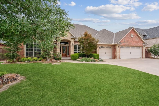 1008 Trisha Ln, Norman, OK 73072 - view of front facade with a garage, a front lawn, roof with shingles, and driveway