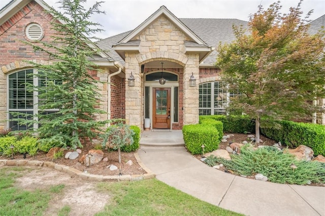 1008 Trisha Ln, Norman, OK 73072 - entrance to property featuring stone siding, roof with shingles, and brick siding