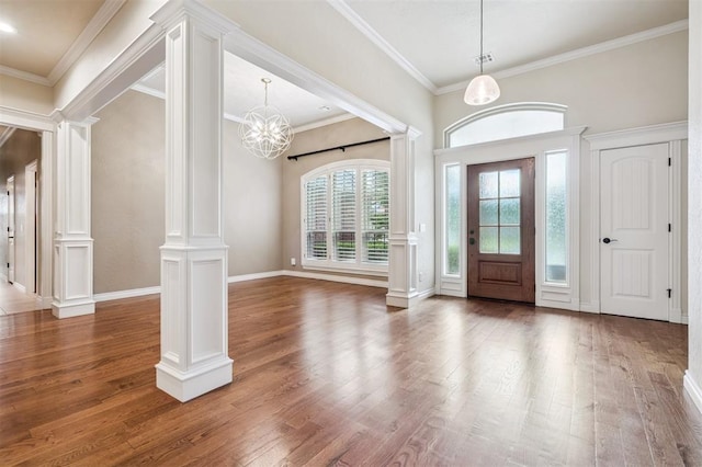 1008 Trisha Ln, Norman, OK 73072 - foyer with decorative columns, wood finished floors, ornamental molding, and a chandelier