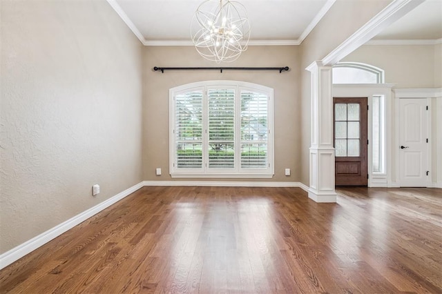 1008 Trisha Ln, Norman, OK 73072 - foyer entrance featuring a chandelier, ornate columns, wood finished floors, and ornamental molding