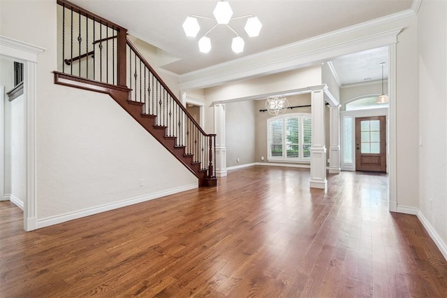 1008 Trisha Ln, Norman, OK 73072 - foyer entrance featuring a chandelier, wood finished floors, stairway, ornate columns, and ornamental molding