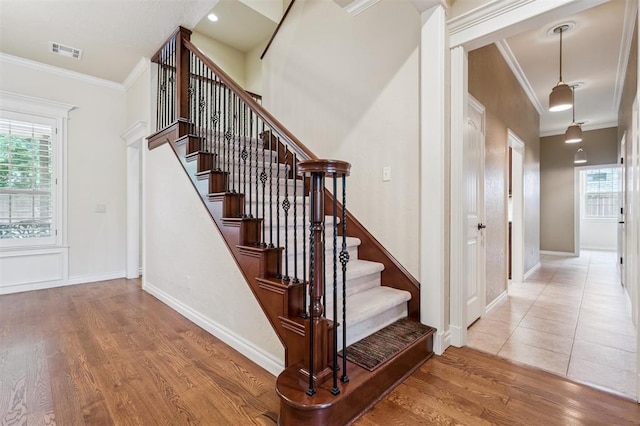 1008 Trisha Ln, Norman, OK 73072 - staircase with crown molding, wood finished floors, and healthy amount of natural light