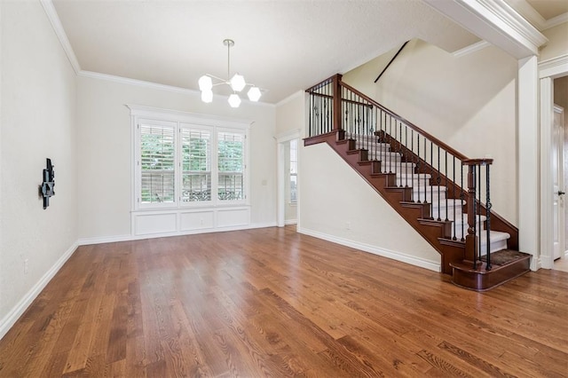 1008 Trisha Ln, Norman, OK 73072 - unfurnished living room featuring stairway, a chandelier, wood finished floors, and crown molding