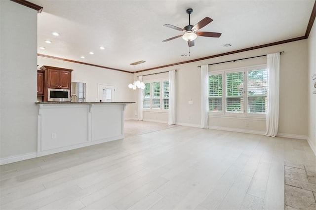 1008 Trisha Ln, Norman, OK 73072 - unfurnished living room with ornamental molding, a ceiling fan, light wood finished floors, recessed lighting, and a chandelier