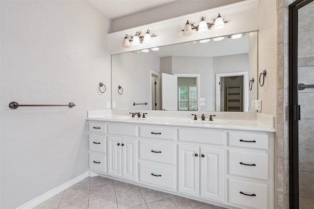 1008 Trisha Ln, Norman, OK 73072 - bathroom featuring double vanity, tile patterned floors, and a shower with door