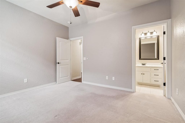 1008 Trisha Ln, Norman, OK 73072 - unfurnished bedroom with light colored carpet, connected bathroom, a textured wall, and a ceiling fan