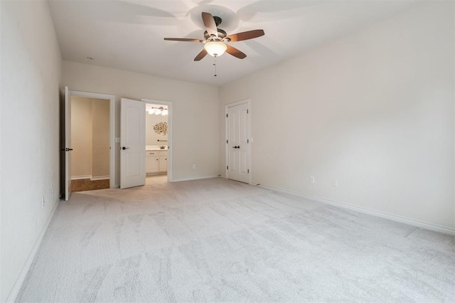 1008 Trisha Ln, Norman, OK 73072 - unfurnished bedroom with light carpet, ensuite bath, and a ceiling fan