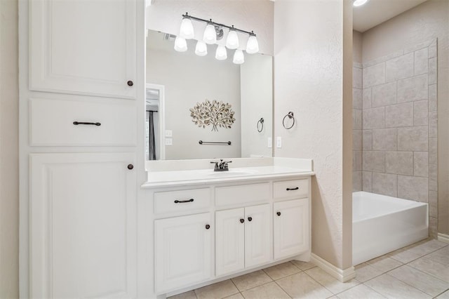 1008 Trisha Ln, Norman, OK 73072 - bathroom featuring vanity, tile patterned floors, a textured wall, and washtub / shower combination
