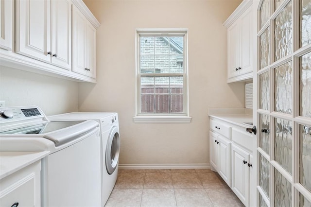 1008 Trisha Ln, Norman, OK 73072 - washroom with independent washer and dryer, cabinet space, and light tile patterned flooring