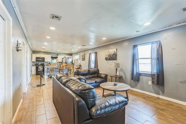 321 W 1st St, Wewoka, OK 74884 - living room featuring recessed lighting, light wood finished floors, and ornamental molding