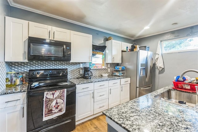 321 W 1st St, Wewoka, OK 74884 - kitchen featuring black appliances, plenty of natural light, white cabinets, and crown molding
