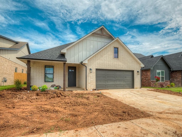 6609 NW 147th St, Oklahoma City, OK 73142 - view of front of property with board and batten siding, driveway, brick siding, and roof with shingles