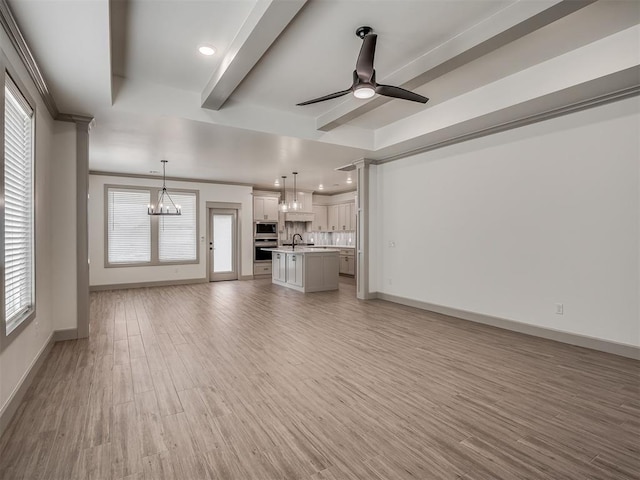 6609 NW 147th St, Oklahoma City, OK 73142 - unfurnished living room featuring a chandelier, ceiling fan, plenty of natural light, light wood finished floors, and recessed lighting